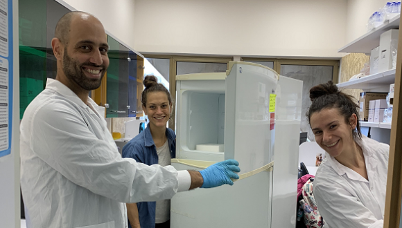 a group of lab students cleaning the refrigerator