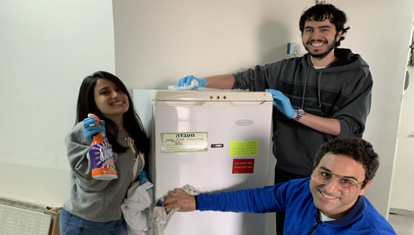 a group of lab students cleaning the refrigerator